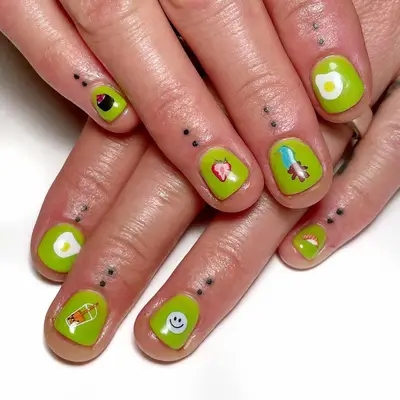 A lime green manicure with sticker accents
