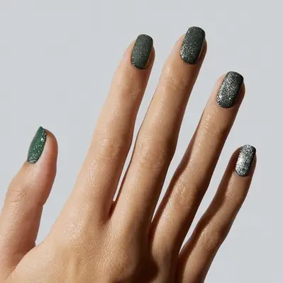 Close up of a green velvet manicure on short, square nails