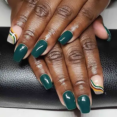 Close up of a dark green manicure with wavy accent nails