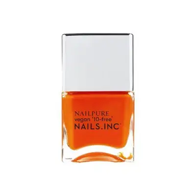 Bright orange nail polish on a white background.