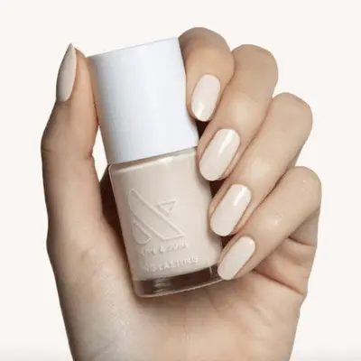 Shimmery mauve bottle of nail polish on a white background.