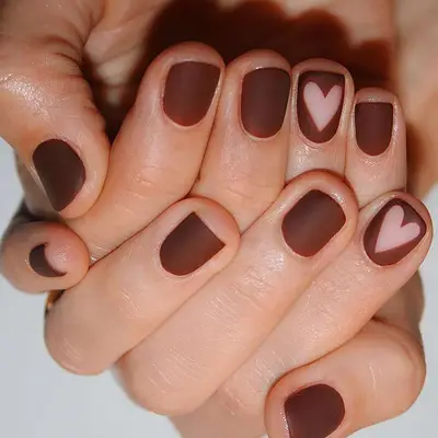 Matte brown nails with negative space heart details