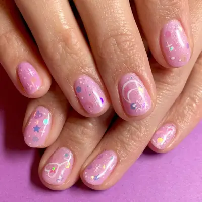 Millenial pink manicure with star, heart, and moon sparkles