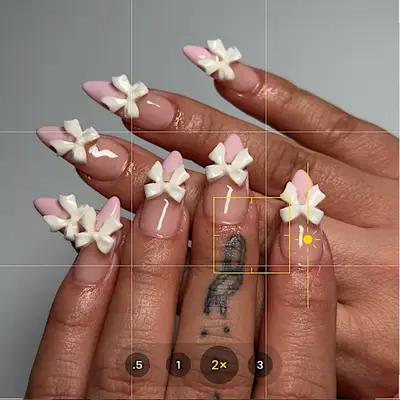 Millennial pink French manicure with 3D bows.