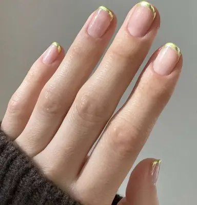 A French manicure with gold tips