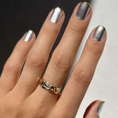 A silver manicure with gold tips