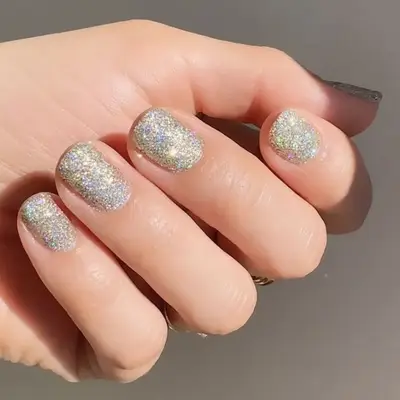 A glittery textured manicure in silver and gold