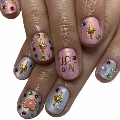 A pastel manicure with gemstone designs and details