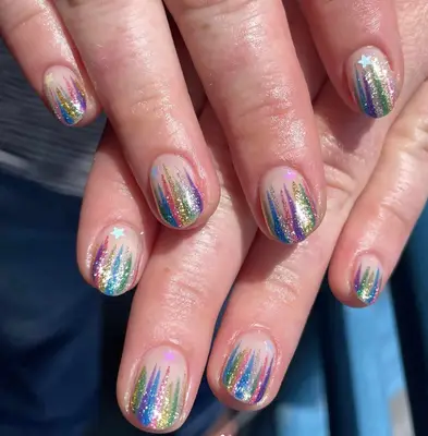 A manicure with rainbow stripes and star details