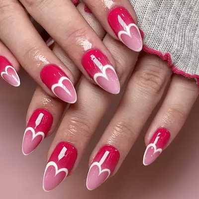 Hot pink nails with a white french tip, extending into a heart shape. 