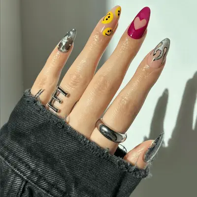 multi manicure with stars, flames, and hearts