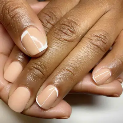 peach manicure with white designs