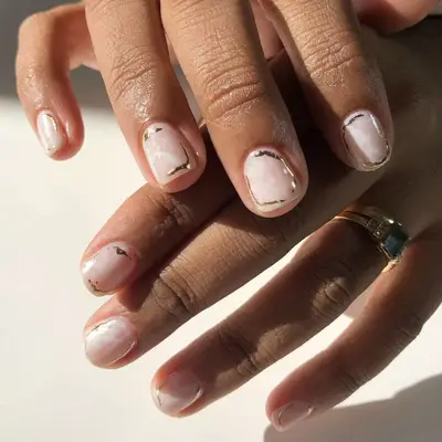 opal inspired short nails with gold accents