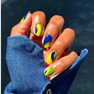 Blue, yellow, and green graphic manicure