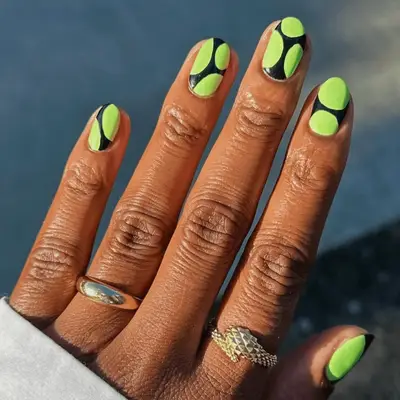 Neon green and black nails with circles
