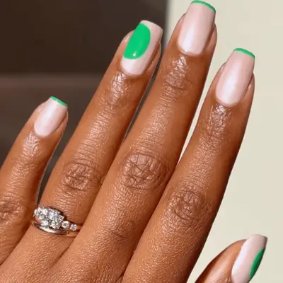 Shimmery French manicure with green tips and abstract blob detail