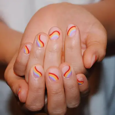 model with matte rainbow nails