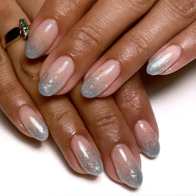 Manicure with chrome French tips and scattered confetti glitter