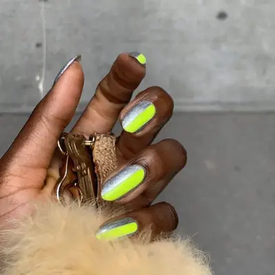 Half silver, half neon green manicure