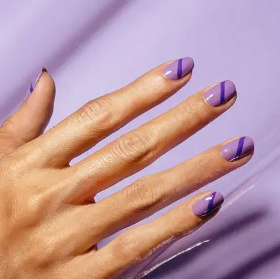 Purple nails with dark purple diagonal line across each nail