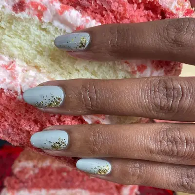 Pale blue nails with dusting of gold glitter