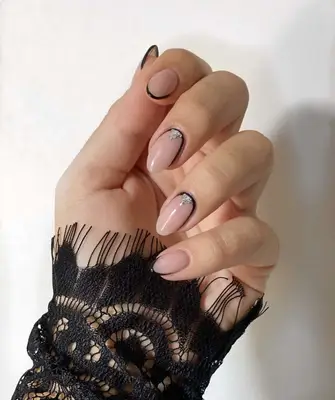 Nude nails with black tips and metallic triangle cuticles