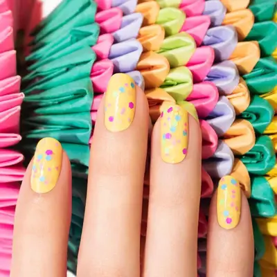 Bright yellow nails with multicolored confetti
