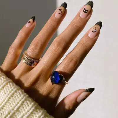 Metallic black french manicure with celestial nail art