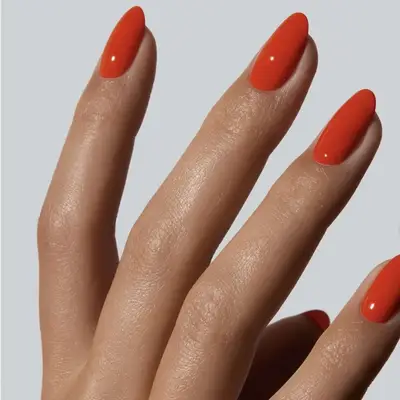 A hand showing manicured nails with a smooth finish, emphasized fingers
