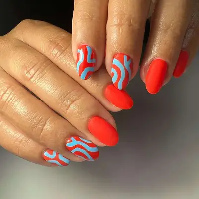 manicure with coral base and blue lines