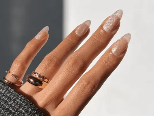 woman with nude sparkly manicure 