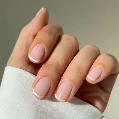 Neutral manicure with white baby French tips