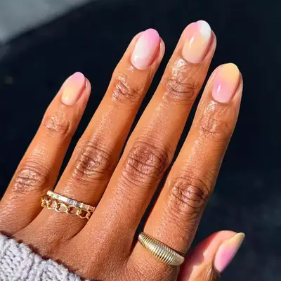 close up of pink and orange gradient manicure