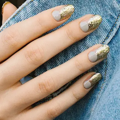 Negative space manicure with gold glitter and shiny gray elements