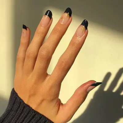 French manicure with dark tips and sparkle detail