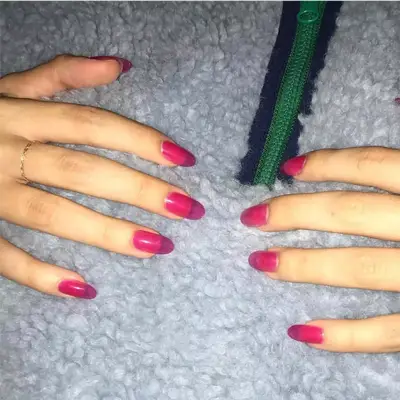 Sheer hot pink jelly nails on a gray fleece
