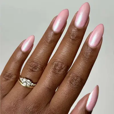 A hand displaying a ring and manicured nails