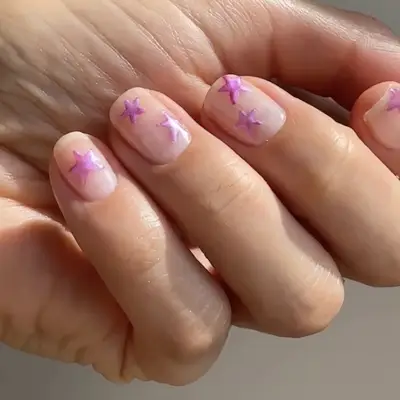 Manicured nails with small decorative stars