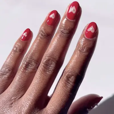 red manicure with hearts and pearls