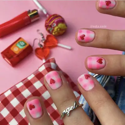 pink and white gingham print manicure with heart accents
