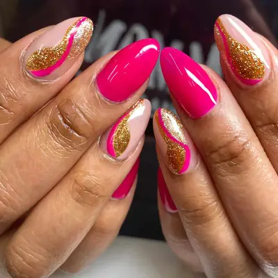 a hot pink and gold manicure with swirls