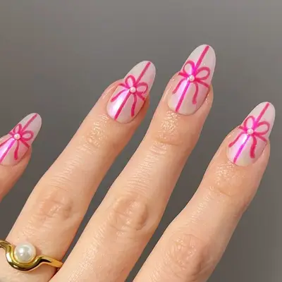 a pale rose manicure with hot pink bows