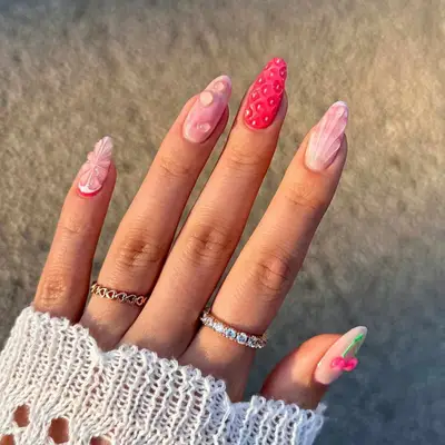 nails with light pink and fuchsia base with clear droplet accents and cherry design