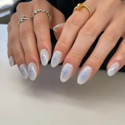 gray nails with soft blue and silver cross