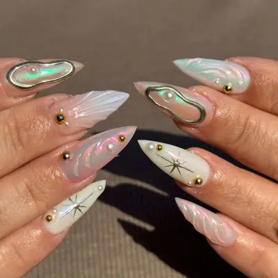 nails with iridescent aquamarine polish and bronze 3D design 