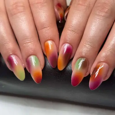 nails with soft plum, orange, green, and brown tones
