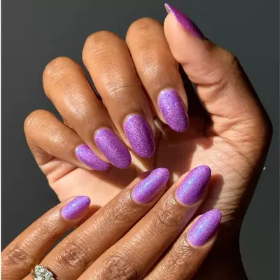 Electric purple sparkly manicure.