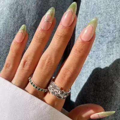 French Manicure with green sparkly tips and silver detailing.