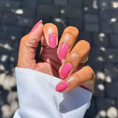 Barbie pink sparkly manicure.