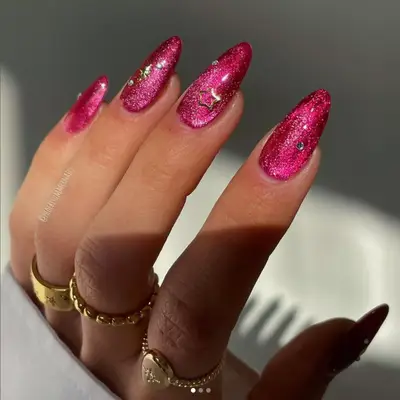 Hot pink sparkle manicure with stars.